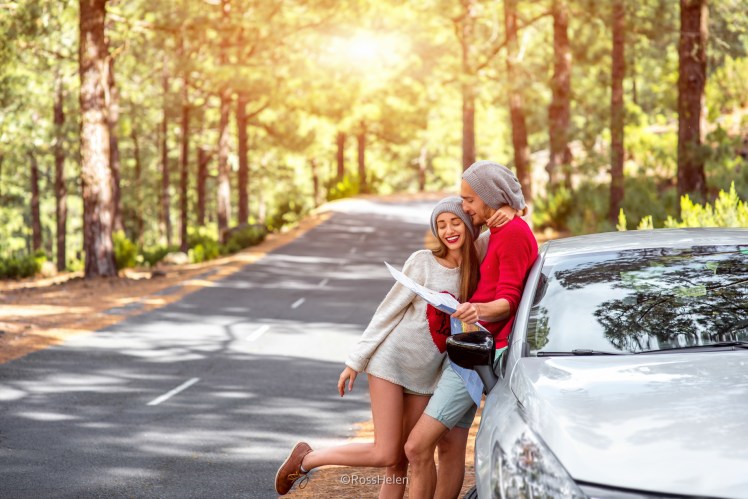 Couple traveling by car in the forest